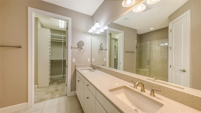 bathroom featuring tile patterned flooring, vanity, and an enclosed shower