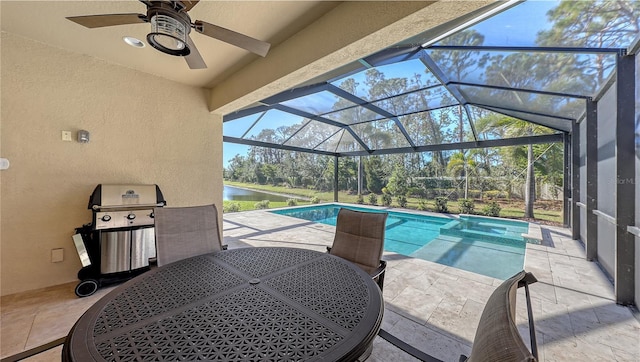 view of pool with a lanai, a patio area, area for grilling, and a water view