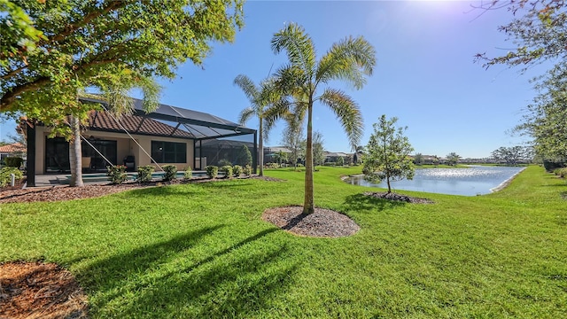 view of yard featuring a lanai and a water view