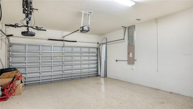 garage featuring electric panel and a garage door opener