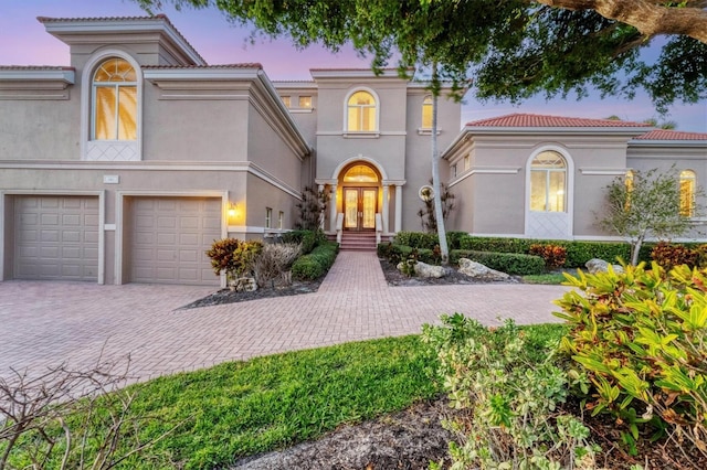 mediterranean / spanish-style home featuring a garage