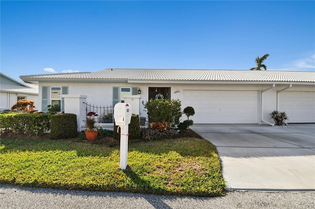 single story home featuring a front yard and a garage