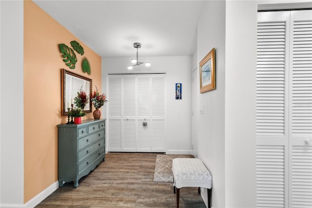 entryway featuring wood-type flooring and an inviting chandelier