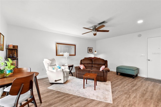 living room with ceiling fan and wood-type flooring