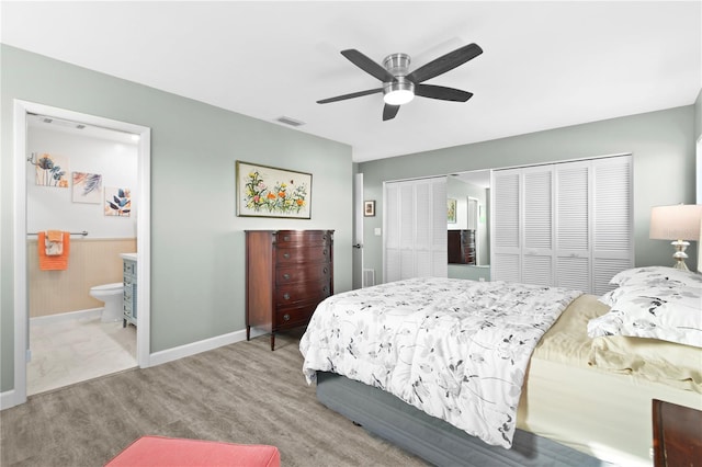 bedroom with ceiling fan, light wood-type flooring, and ensuite bath