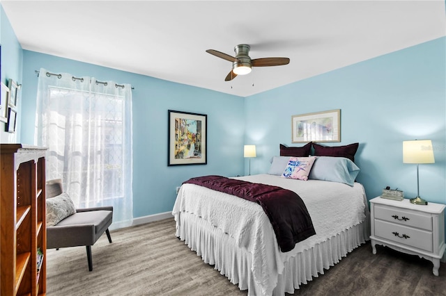 bedroom with ceiling fan and hardwood / wood-style flooring