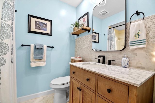 bathroom featuring tile patterned floors, decorative backsplash, vanity, and toilet