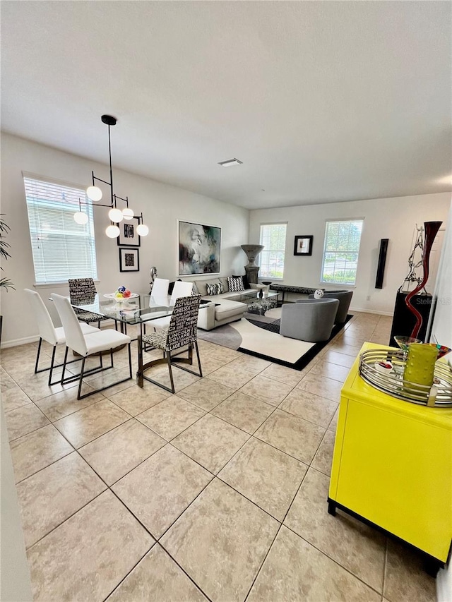 dining room featuring light tile patterned floors and a chandelier