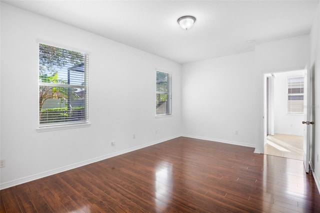 spare room with dark hardwood / wood-style flooring