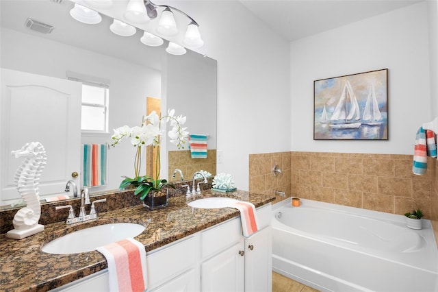 bathroom featuring vanity and a bath