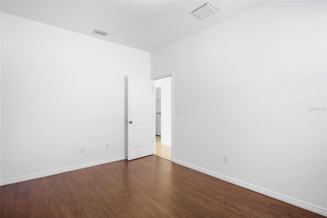 empty room with dark hardwood / wood-style floors