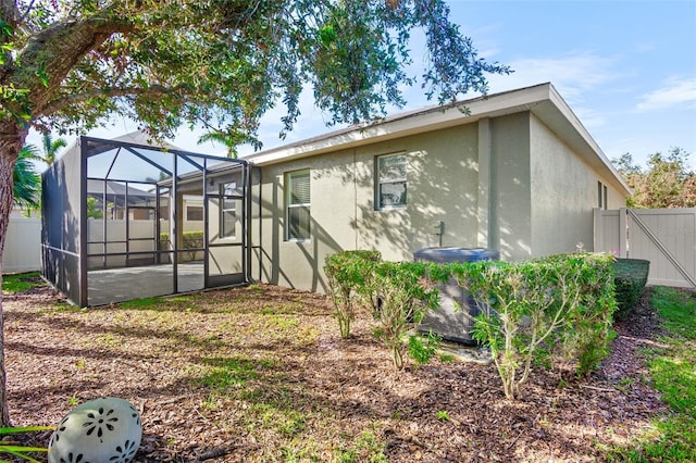 rear view of house featuring a lanai