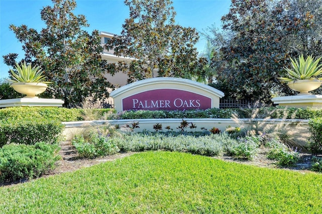 community / neighborhood sign with a yard