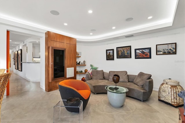 living room featuring a raised ceiling