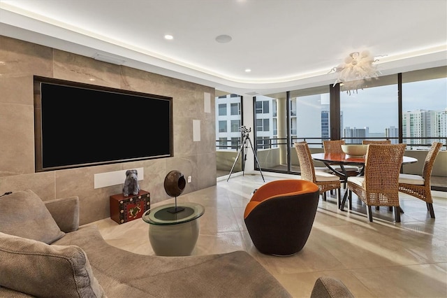 living room featuring light tile patterned flooring and tile walls