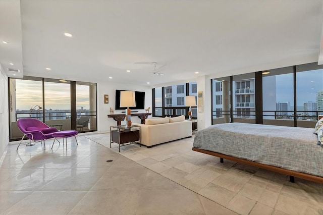 bedroom featuring expansive windows, access to exterior, and multiple windows