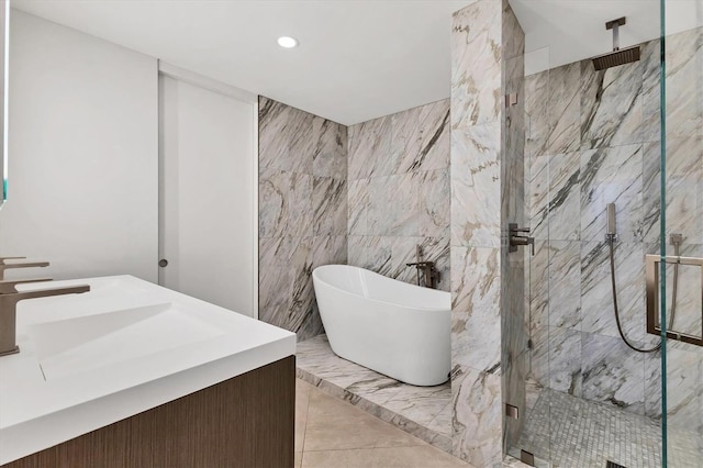 bathroom with vanity, tile walls, and separate shower and tub