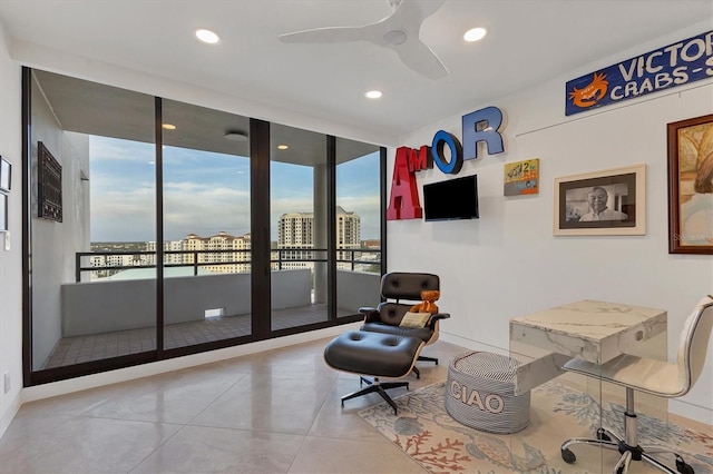 sitting room featuring light tile patterned flooring and ceiling fan