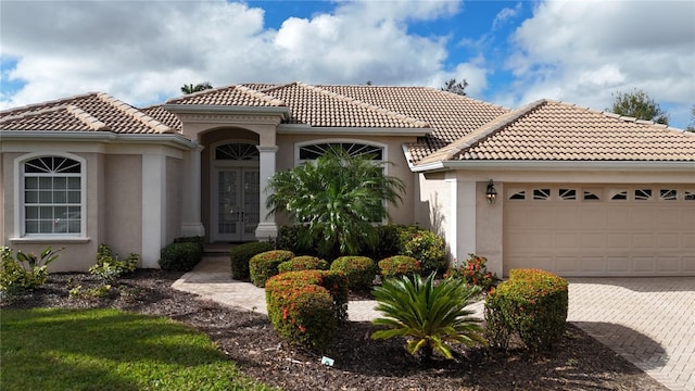 mediterranean / spanish-style house with a garage