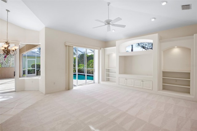 unfurnished living room with ceiling fan with notable chandelier, light colored carpet, built in features, and vaulted ceiling