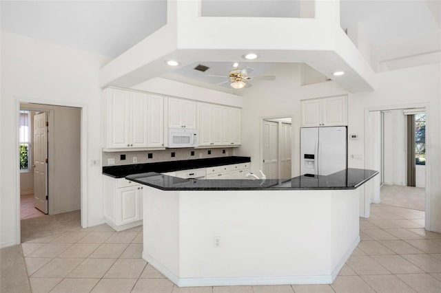 kitchen with ceiling fan, white cabinets, white appliances, and a kitchen island