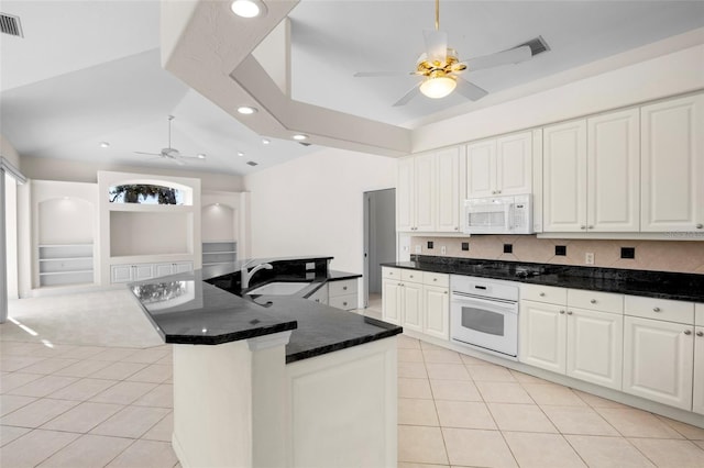 kitchen with light tile patterned flooring, white appliances, white cabinetry, and sink