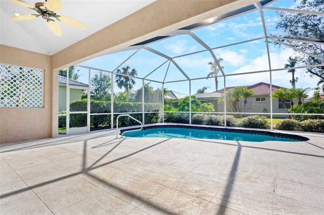 view of swimming pool featuring ceiling fan, a lanai, and a patio