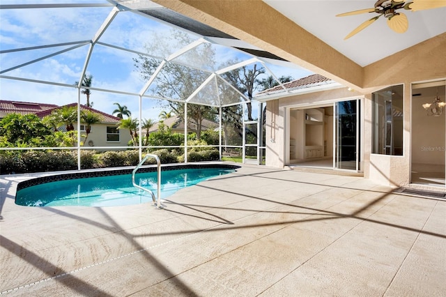 view of pool featuring ceiling fan, a patio area, and glass enclosure