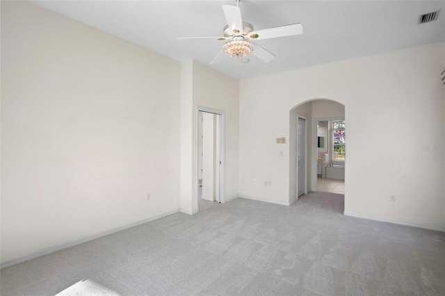 carpeted spare room with ceiling fan