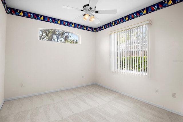 carpeted empty room featuring ceiling fan