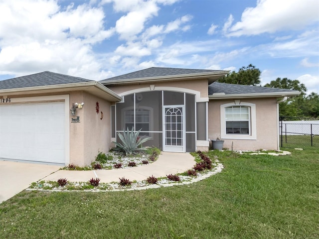 view of front of home featuring a front yard and a garage