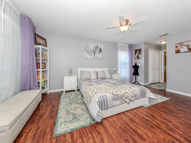 bedroom featuring a closet, ceiling fan, and dark wood-type flooring