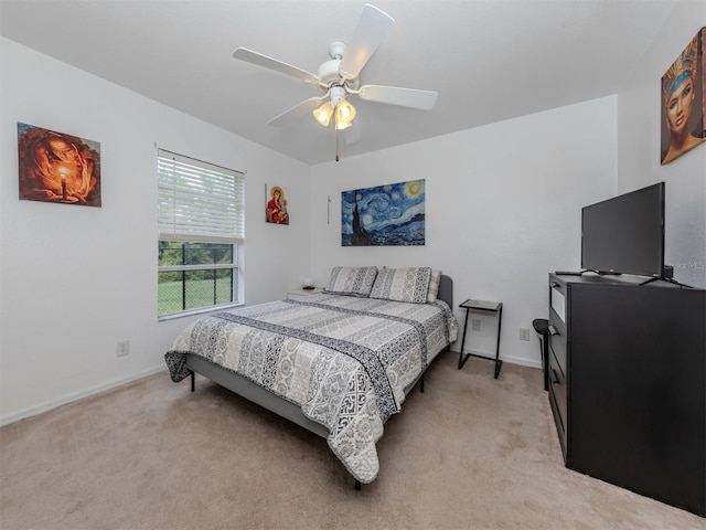 bedroom featuring light colored carpet and ceiling fan