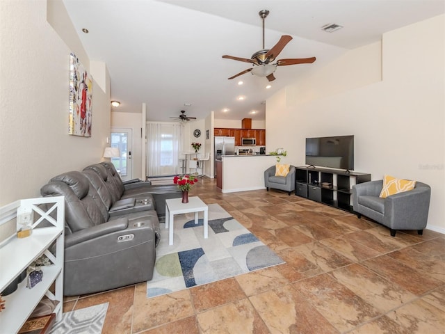 living room with ceiling fan and lofted ceiling