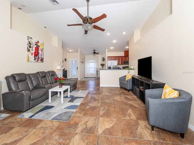 living room featuring ceiling fan and vaulted ceiling