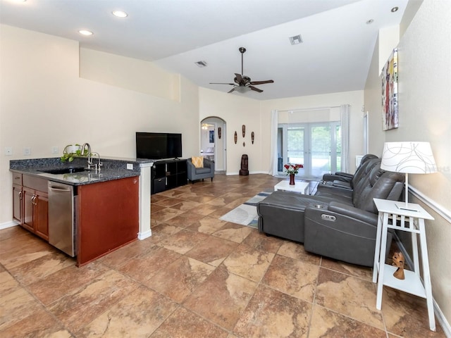 living room featuring vaulted ceiling, ceiling fan, and sink