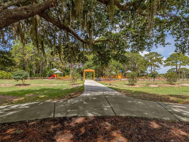 view of community with a playground and a lawn