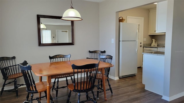 dining space with dark wood-type flooring