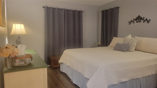 bedroom with dark wood-type flooring