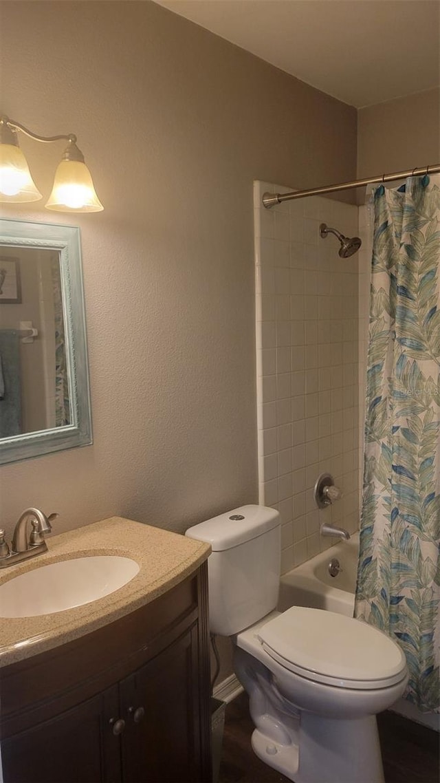 full bathroom featuring shower / bath combo, vanity, and toilet