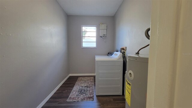 washroom with electric water heater, dark hardwood / wood-style floors, and independent washer and dryer