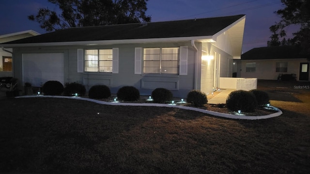 property exterior at dusk featuring a garage