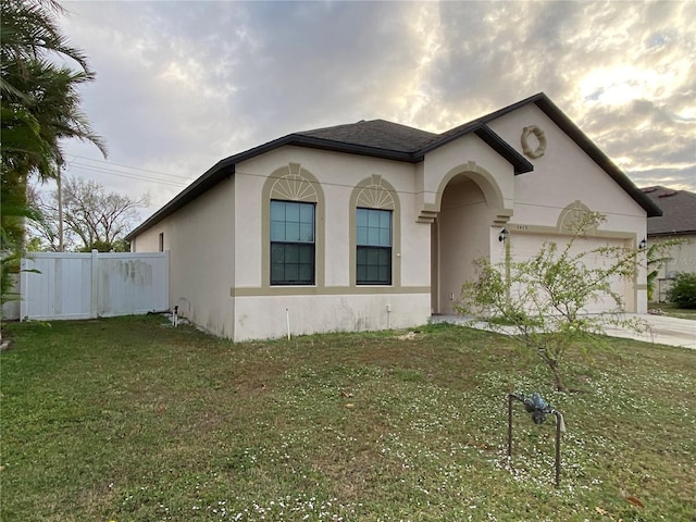 view of front of house with a front lawn and a garage