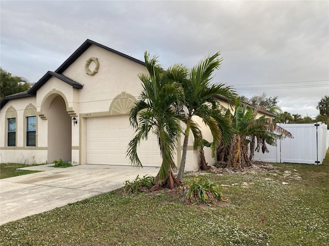 view of front facade with a front yard and a garage