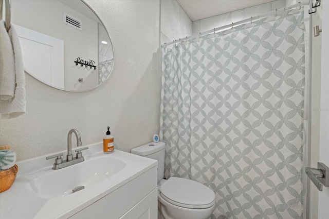 bathroom with vanity, a shower with curtain, and toilet