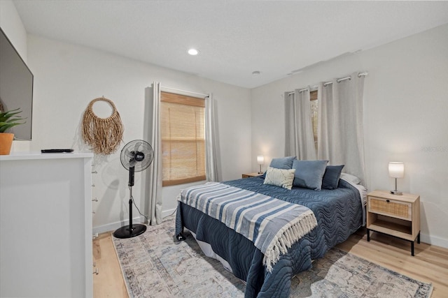 bedroom featuring hardwood / wood-style flooring and multiple windows