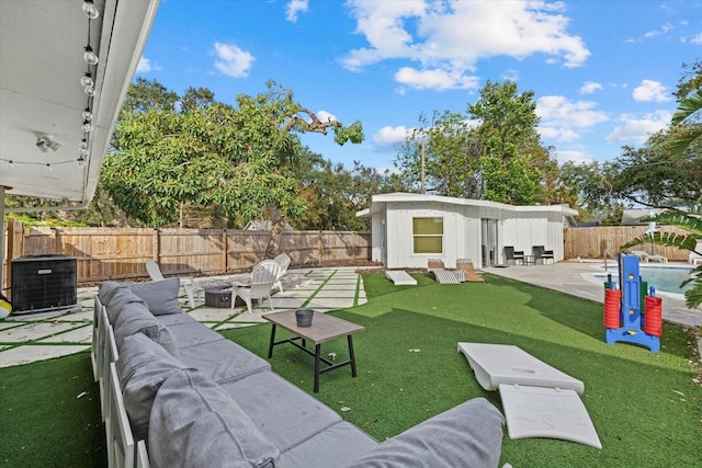 view of yard with an outdoor living space with a fire pit, central AC unit, and a patio area