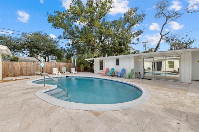 view of swimming pool with a patio area