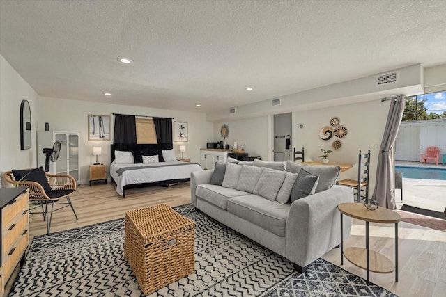 bedroom featuring a textured ceiling and light wood-type flooring