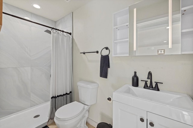 bathroom with vanity, toilet, and walk in shower